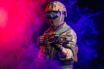 A soldier is depicted holding a drone while wearing stealth gear for military operations