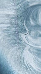 Glitter paint spill. Liquid silver texture. Defocused gray color metallic shimmering sand particles...