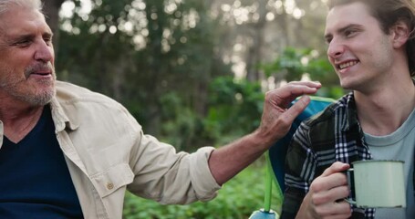 Camping, man and father toast in nature on outdoor holiday vacation for chat, family and natural forest. Talking, coffee and senior dad drinking with happy son on adventure in Australia and woods