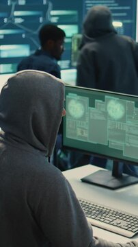 Vertical Video Cyber security specialist conducting cyber surveillance and threat detection in a governmental agency. Professional hackers team managing cybercrime prevention and malware detection