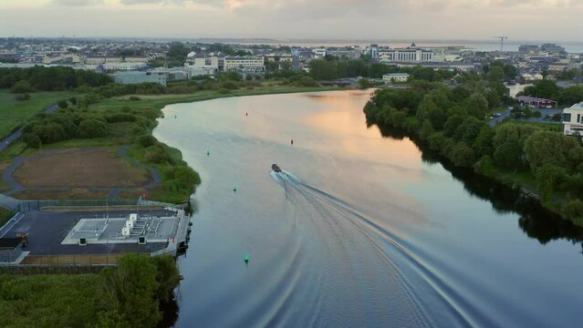 Speedboat on Corrib River following the buoyage, revealing the stunning cityscape of Galway City, Ireland.