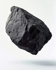 Obraz premium A black rock floating in the air.