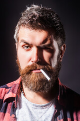 Bearded man smoke cigarette. Man retro beauty. The prickly bristle added character to rugged...