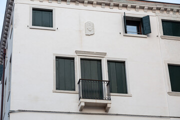 Typical building with balcony and windows in Venice