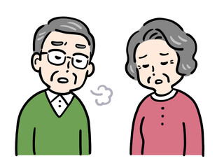 肩を落としため息をつくシニア夫婦