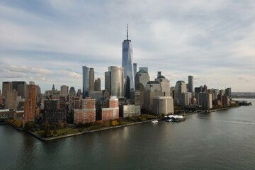Fototapeta premium Manhattan, New York skyline from drone. Manhattan over the Hudson river. Manhattan NYC cityscape, aerial view. Manhattan downtown skyline with urban skyscrapers over Hudson river.