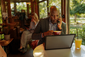 African-American man working on his laptop in a cafe