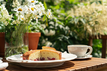 Sponge cake with berries. tea party on the summer terrace in the garden
