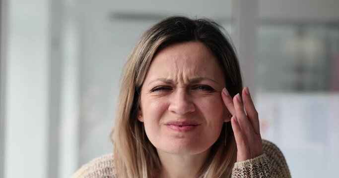 Woman squints eyes trying to read important information