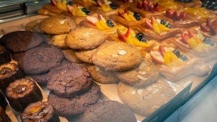 Bakery showcase with cookies and  puff pastry cakes.