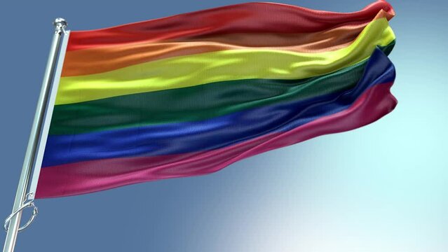 a flag of rainbow colors flutters in the wind
