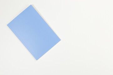 Top view of blue notebook on white background. School, office wallpaper. Flat lay, copy space.