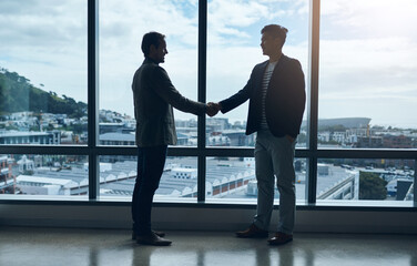 Introduction, handshake and business people meeting at window for welcome, networking or onboarding. B2b deal, agreement and men shaking hands together for partnership, support and client opportunity