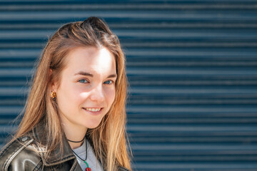 portrait blonde girl with blue eyes on the street outdoors