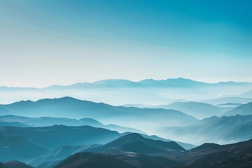 Naklejka premium A breathtaking view of a distant mountain range with layered peaks under a clear sky, showcasing natural beauty and serene landscapes