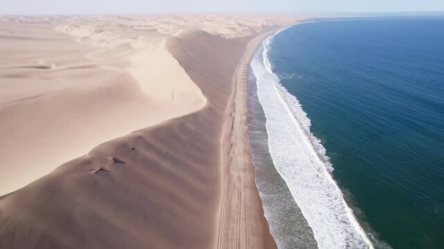 Ocean and dunes, morning, sunrise landscape.. Walvis Bay Namibia Africa. Aerial footage, 4k Dlog to Rec.709