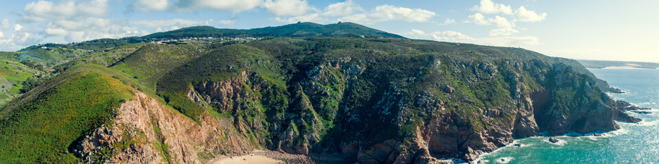 Panoramic view of Cabo da Roca. Rocky seascape. Assentiz Beach. Region of Cape Roca, Atlantic Ocean, Portugal. Horizontal banner