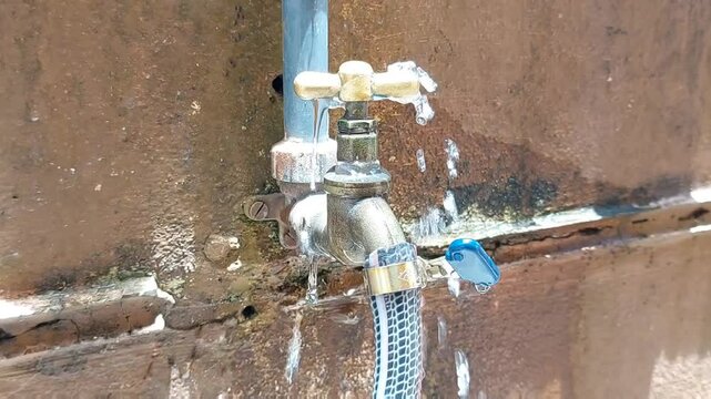 Water wasted - leaking from defective tap 