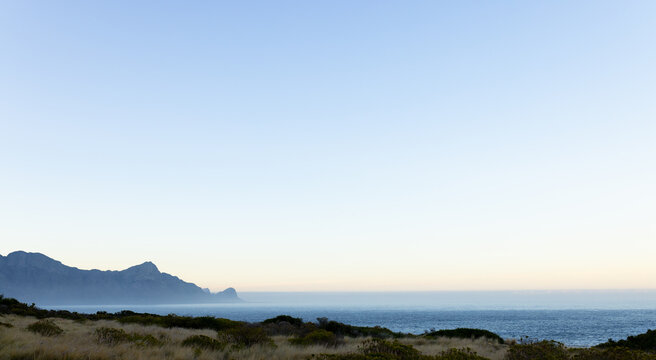Scenic view of mountains and ocean under clear sky during mountain hike, copy space