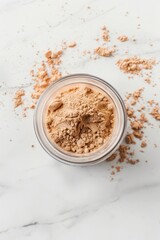 Close-up of brown powder in a container on a white background.