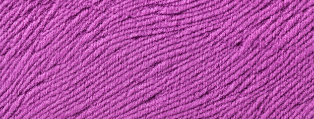 Texture of purple woolen textile background from soft wool material, macro. Structure of lilac fabric