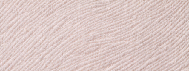 Texture of woolen light beige textile background from soft wool material, macro. Structure of cream fabric