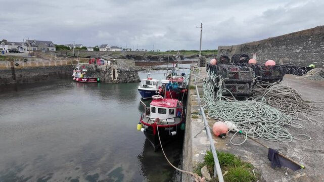 Ireland epic locations sheltered behind the seawall, small fishing boats at low tide Slade harbour the Hook Wexford