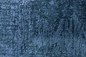 Navy blue fluffy background of soft, fleecy fabric. Texture of dark denim velveteen textile