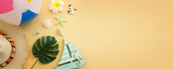 nautical concept seashells, beach hat and ball over pastel yellow background. vintage style