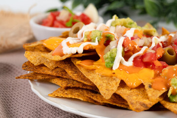 Crispy tortilla chips topped with melted cheddar cheese and salsa	