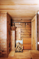 Stacked firewood near the log wall of a village house