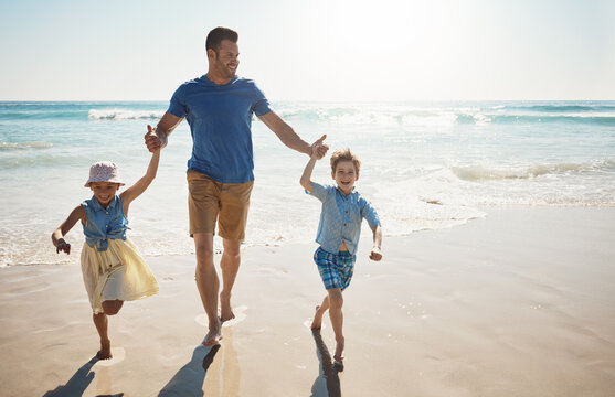 Happy, holding hands and dad with children at beach on holiday, vacation and tropical adventure. Family, travel and kids with father by ocean for bonding, playing in waves and fun outdoors on weekend