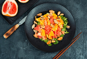 Salad with mussels on the plate.
