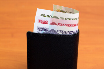 Uruguayan peso in the black wallet