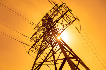 Metal electric pole against the backdrop of the sunset