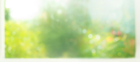 Blur big window with abstract green garden  background.glass wall