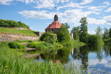 The ancient fortress of Korela on the riverbank with a reflection. Priozersk, Leningrad region, Russia