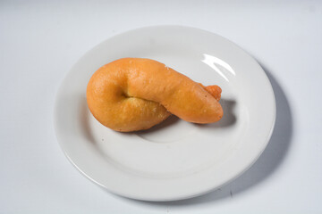 Collection of donuts on white ceramic plate, isolated objects