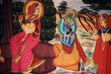 Radha playing the flute while Krishna watches. Rajasthani painting. India.