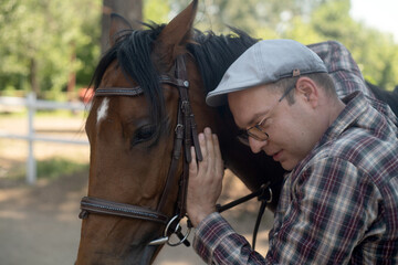a person with a horse, hugging