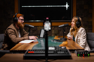 Joyful young stylish radio show hosts record fresh podcast episode in loft studio