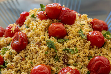 A colourful tomato and cous cous salad as part of a summer buffet