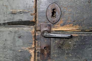 Old Rusty Door Handle with Lock in Switzerland.