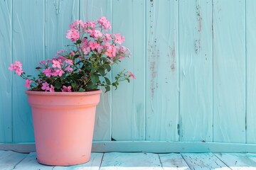 Fototapeta premium A pink flower pot with pink flowers sits on a wooden floor