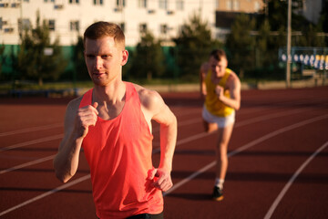 Obraz premium Athletes compete in running at the stadium