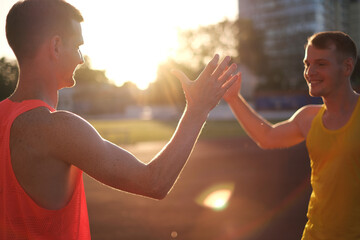 Athletes runners greet each other at the stadium