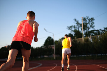 Athletes compete in running at the stadium