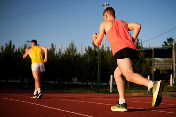 Athletes compete in running at the stadium