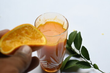 Fresh Orange juice on white background. It is a famous fruit juice which contains lots of vitamins like vitamin C, folate and potassium. Healthy drink. Fruit juice.
