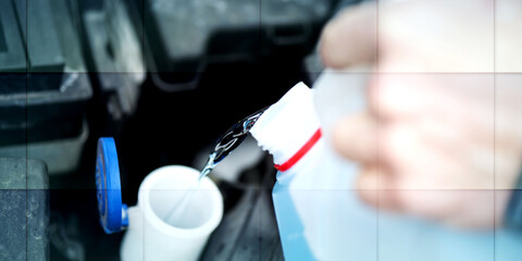 Hands of mechanic pouring windshield washer fluid in a car, geometric pattern